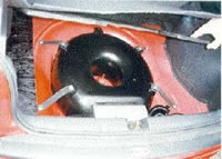 A "donut" tank located in the spare wheel well beneath the boot's false floor.
